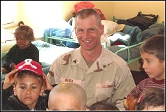 Ned visiting an orphanage during his deployment overseas