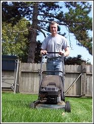 man mowing lawn as part of a humane wildlife prevention plan